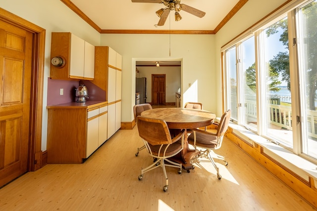 dining area with light hardwood / wood-style flooring, ceiling fan, and ornamental molding