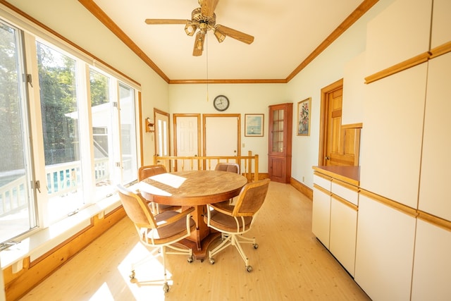 dining space featuring light wood-type flooring, ceiling fan, and ornamental molding