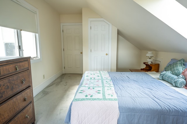 carpeted bedroom with vaulted ceiling