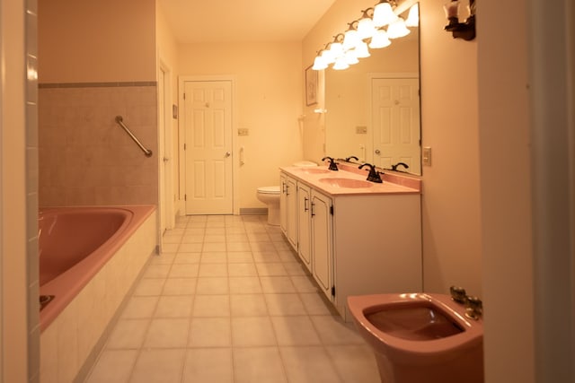 full bathroom with tile patterned floors, vanity, toilet, and tiled shower / bath