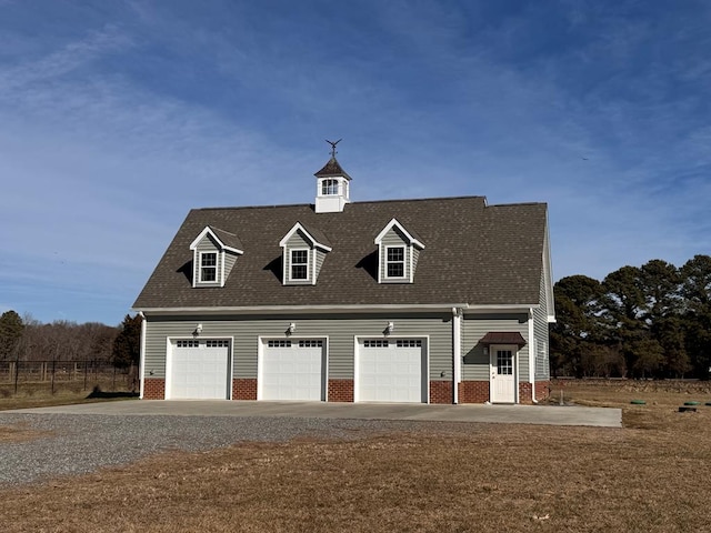 cape cod-style house featuring a garage