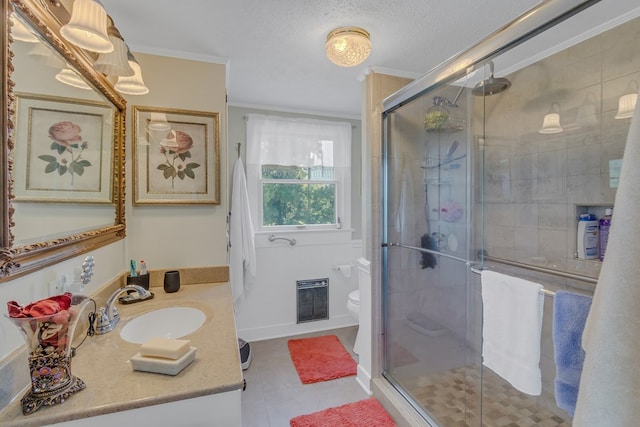 bathroom featuring tile patterned floors, walk in shower, vanity, crown molding, and toilet