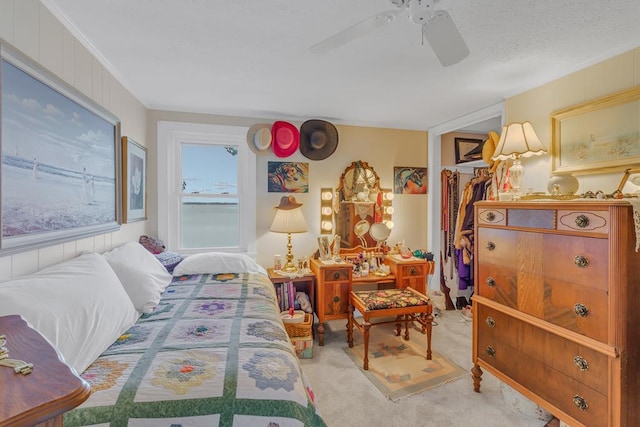 carpeted bedroom featuring a closet, ceiling fan, and crown molding