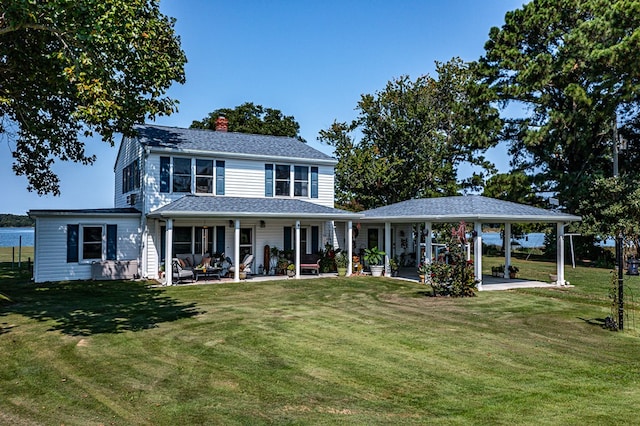 view of front of property featuring a front yard and a patio area