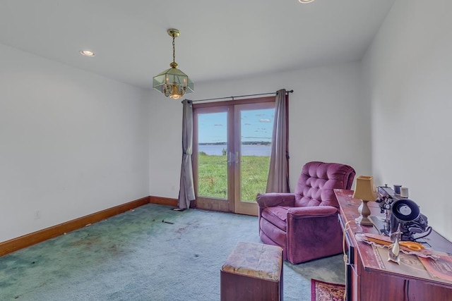 sitting room with light colored carpet and a chandelier