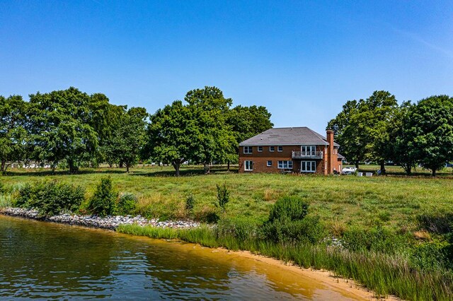 rear view of property with a water view