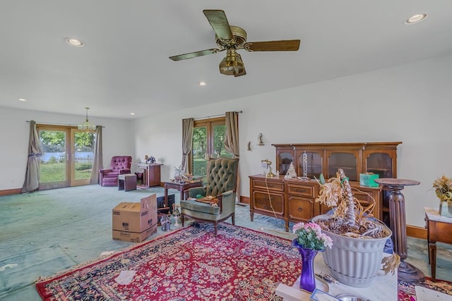 living room featuring ceiling fan and a healthy amount of sunlight