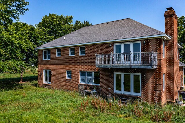 rear view of property with a balcony