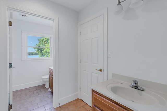 bathroom with tile patterned floors, vanity, and toilet