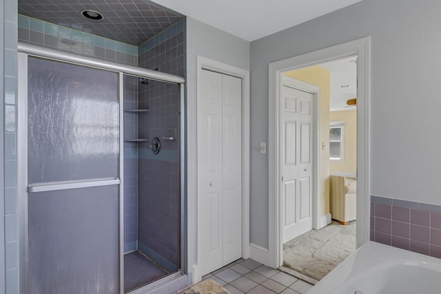 bathroom with separate shower and tub and tile patterned flooring