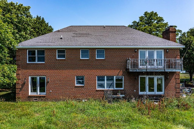 rear view of house featuring a balcony