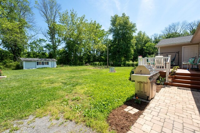 view of yard featuring a wooden deck and an outbuilding