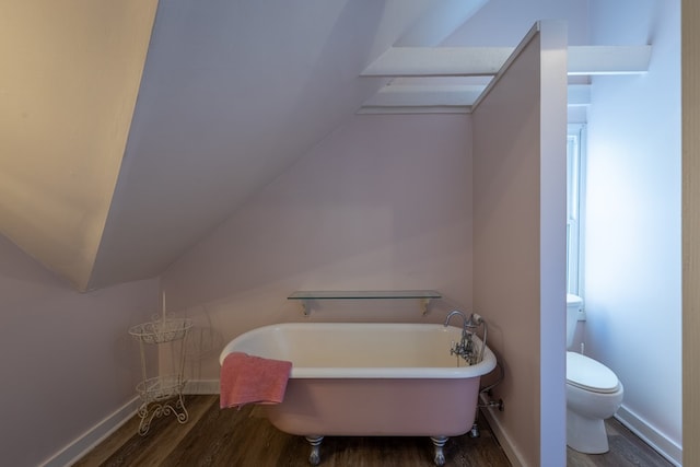 bathroom with hardwood / wood-style floors, toilet, and a bathtub