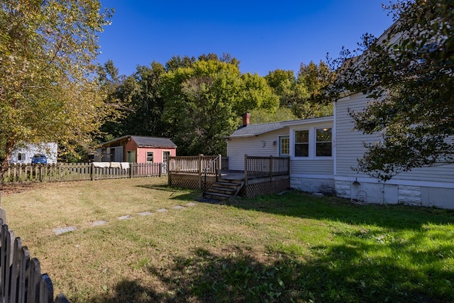 view of yard with a storage shed and a wooden deck