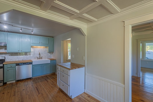 kitchen with sink, ornamental molding, stainless steel appliances, and wooden counters