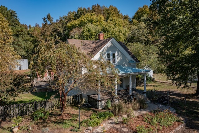 rear view of house featuring a porch