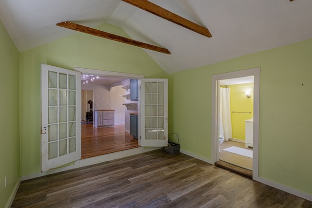 spare room featuring dark hardwood / wood-style flooring, vaulted ceiling with beams, and french doors