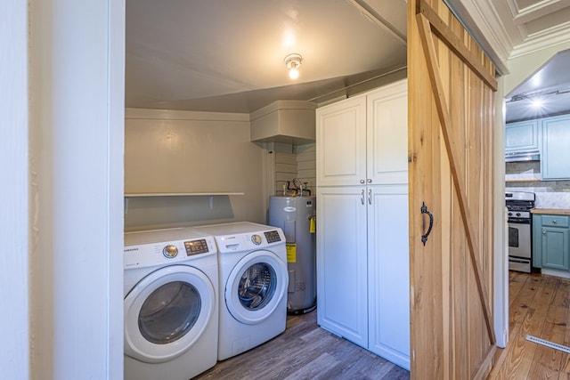 laundry room featuring washing machine and clothes dryer, electric water heater, cabinets, and wood-type flooring