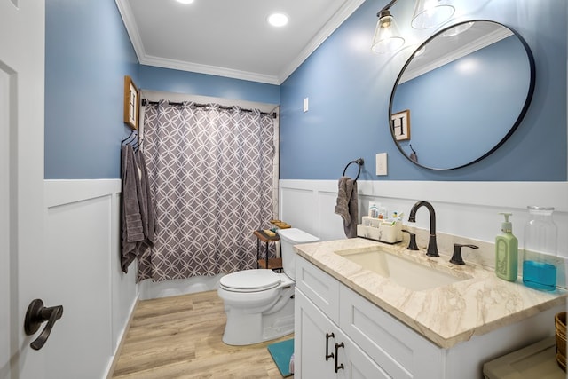 bathroom with vanity, a shower with curtain, toilet, ornamental molding, and wood-type flooring