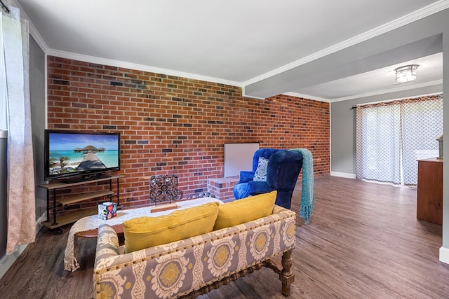 living room featuring dark hardwood / wood-style floors, ornamental molding, and brick wall