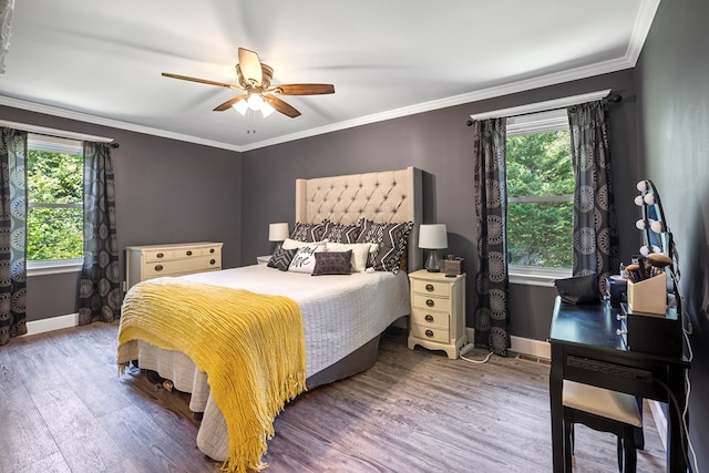 bedroom with hardwood / wood-style floors, ceiling fan, and ornamental molding