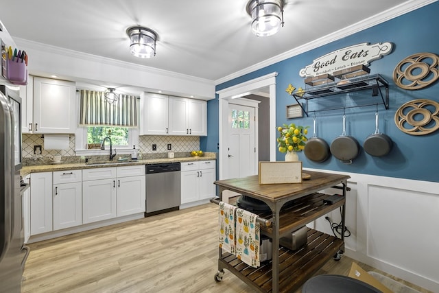 kitchen featuring white cabinetry, dishwasher, sink, tasteful backsplash, and light stone counters