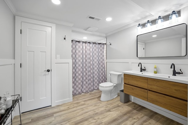 bathroom featuring hardwood / wood-style floors, vanity, toilet, and crown molding