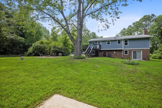 view of yard featuring cooling unit and a wooden deck