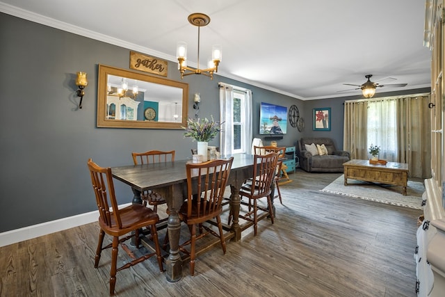 dining area featuring ceiling fan with notable chandelier, dark hardwood / wood-style flooring, plenty of natural light, and crown molding