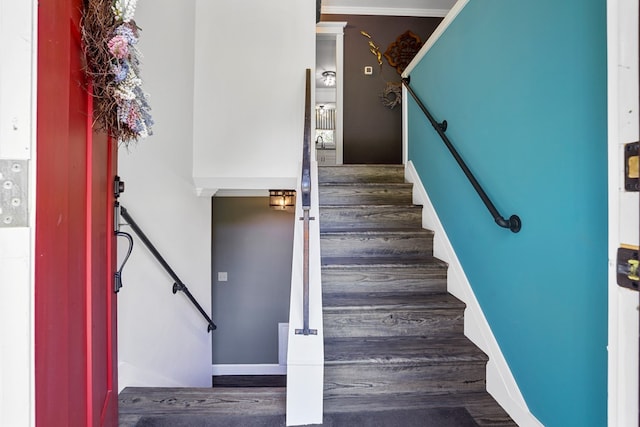 stairway featuring crown molding