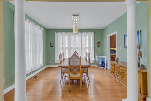 170 Rappa Run Rd, Topping, VA 23169 - dining area with ornate columns, light wood-type flooring, and baseboards
