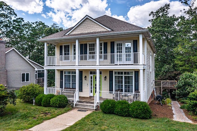 170 Rappa Run Rd, Topping, VA 23169 - view of front of house with covered porch, a balcony, a front yard, and a shingled roof