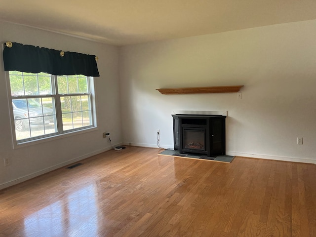 55 Deer Run Dr, Heathsville, VA 22473 - unfurnished living room with wood finished floors and a glass covered fireplace