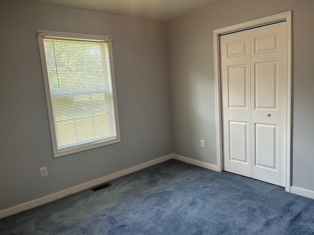 55 Deer Run Dr, Heathsville, VA 22473 - unfurnished bedroom featuring dark colored carpet and a closet