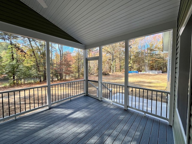 unfurnished sunroom with lofted ceiling