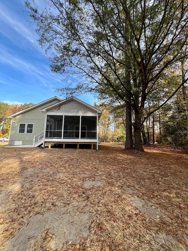 back of property featuring a sunroom