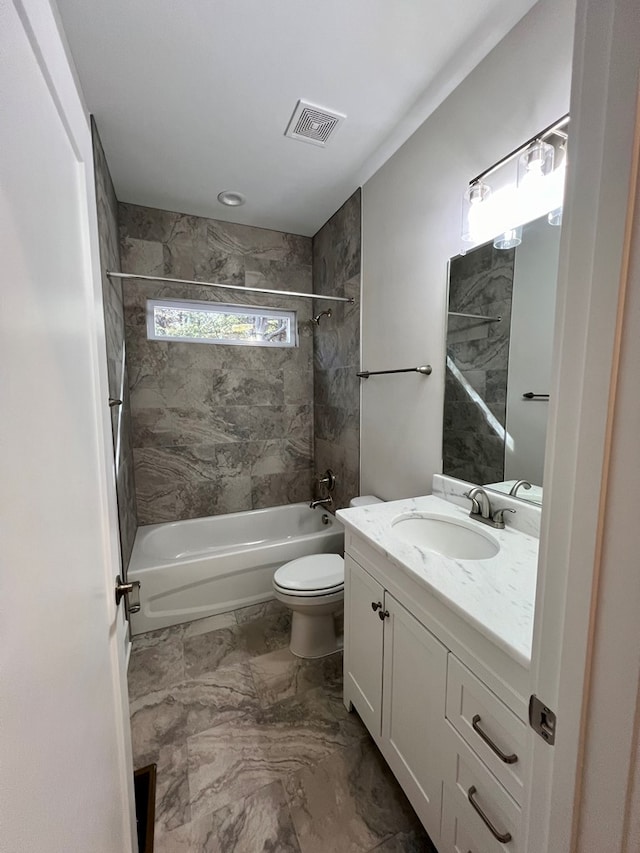 full bathroom featuring vanity, toilet, and tiled shower / bath combo