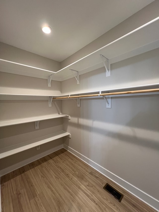 spacious closet featuring hardwood / wood-style flooring