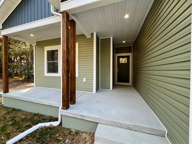 view of exterior entry with a porch