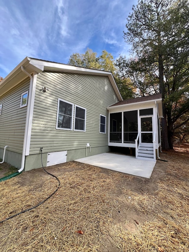 rear view of house with a sunroom and a patio area