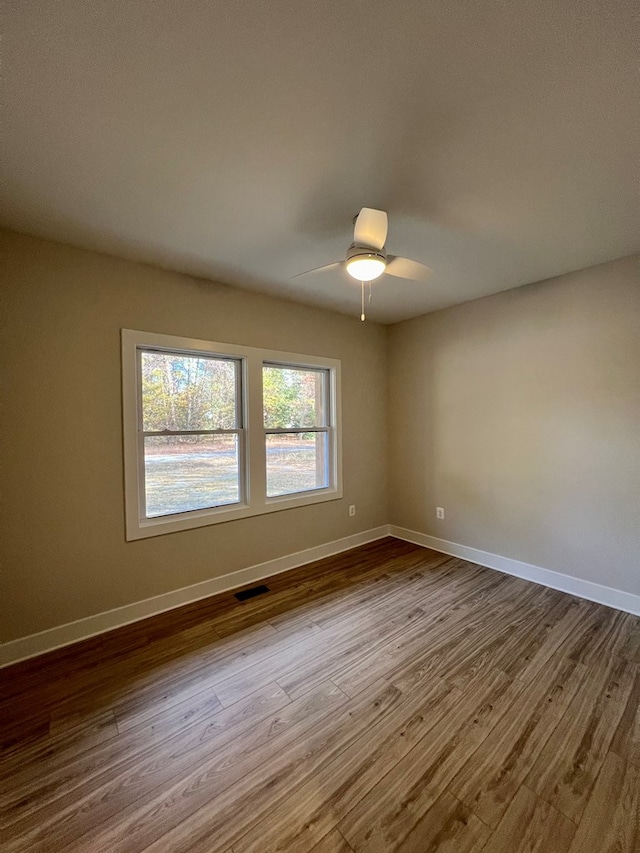 empty room with light hardwood / wood-style flooring and ceiling fan