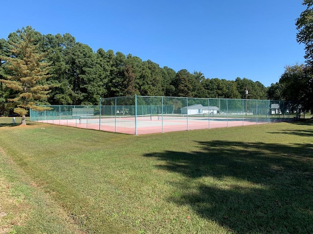 view of sport court featuring a lawn