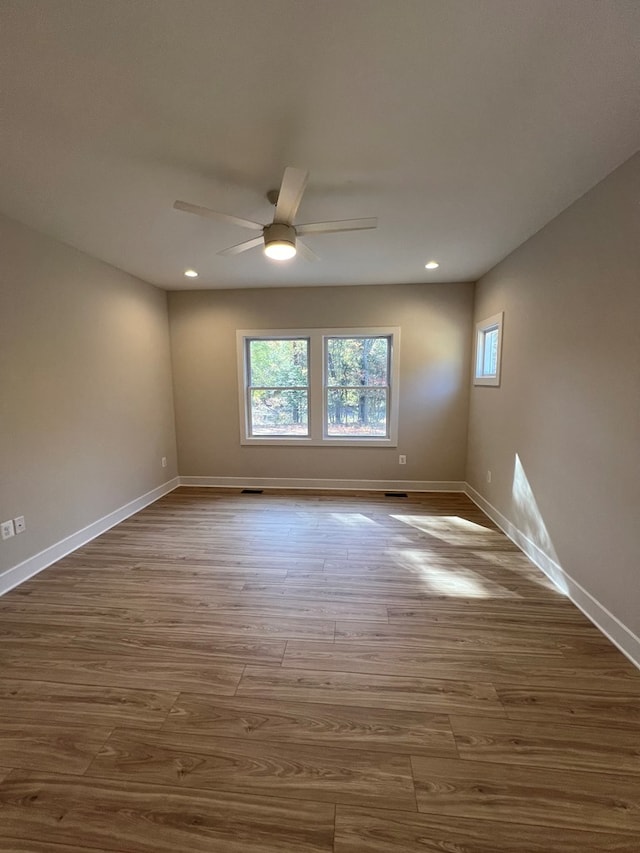 unfurnished room with wood-type flooring and ceiling fan