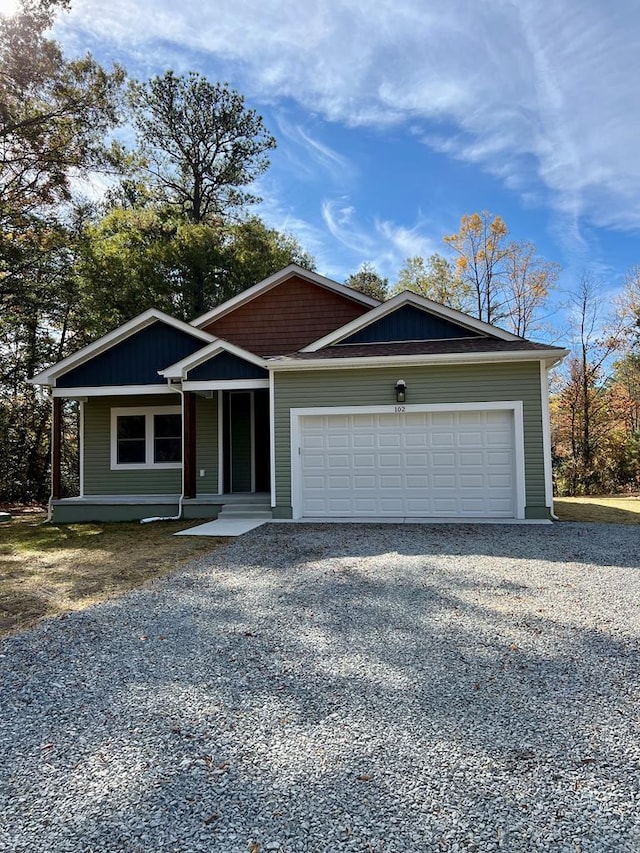 view of front of house featuring a garage and a porch