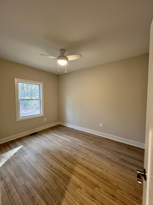 spare room featuring ceiling fan and light hardwood / wood-style flooring