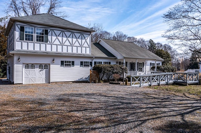 489 Riverview Dr, Heathsville, VA 22473 - rear view of property featuring roof with shingles, an attached garage, driveway, and a deck
