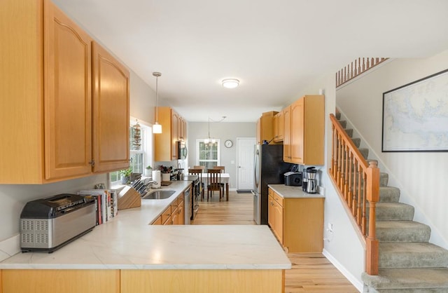 151 Bald Eagle Dr, Montross, VA 22520 - kitchen with a sink, light wood-type flooring, light countertops, and stainless steel appliances