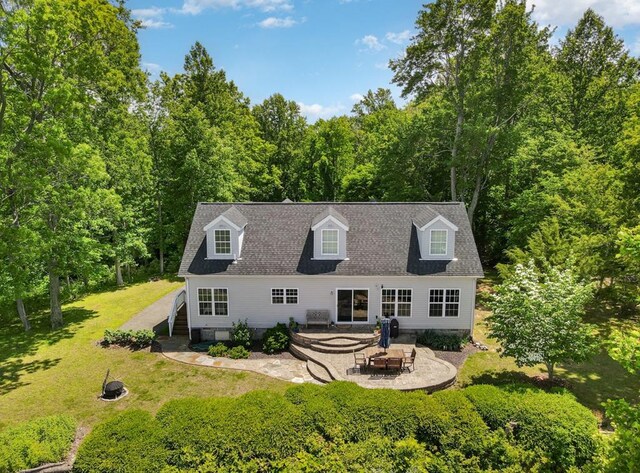 151 Bald Eagle Dr, Montross, VA 22520 - rear view of property with an outdoor fire pit, a patio area, a yard, and a forest view