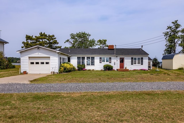 ranch-style home with a storage shed, a front lawn, and a garage