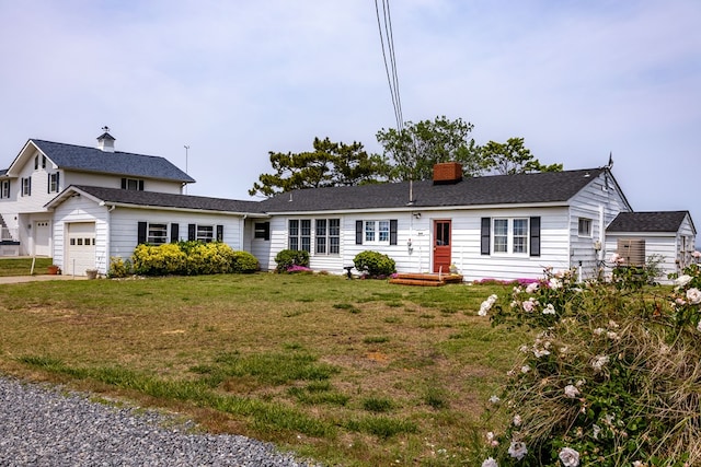 view of front of property with a garage and a front lawn